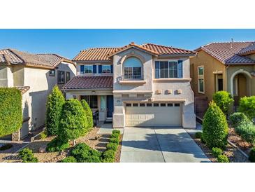 Charming two-story home features a well-manicured yard, two-car garage, and elegant architectural details at 10749 Turquoise Valley Dr, Las Vegas, NV 89144