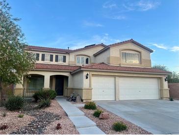 Charming two-story home featuring a two-car garage and well-maintained landscaping at 1921 Moonlight Bluff Ave, North Las Vegas, NV 89084