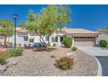 Charming single-story home featuring a well-manicured front yard and attached two-car garage at 1953 Moyer Dr, Henderson, NV 89074