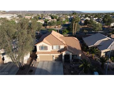 Charming two-story home featuring a beautiful terracotta-tiled roof and attached two-car garage at 2549 Sundew Ave, Henderson, NV 89052
