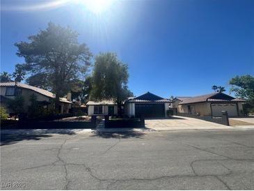 Charming single-story home featuring desert landscaping, a paved driveway, and a secure fenced yard at 3920 Aspencrest Dr, Las Vegas, NV 89108
