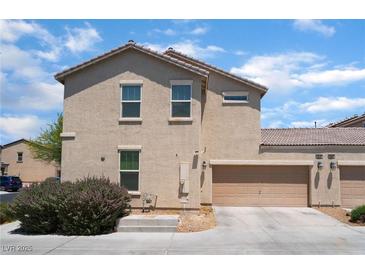 Two story home featuring an attached garage with neutral stucco and tile roof at 4610 Lime Straight Dr, Las Vegas, NV 89115