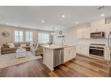 Bright, open-concept living space featuring a plush sectional sofa and stylish decor at 5299 Silver Branch Ave, Las Vegas, NV 89118
