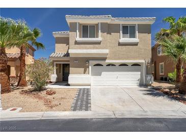Tan two-story home featuring a two car garage, palm trees, and desert landscaping at 576 Foster Springs Rd, Las Vegas, NV 89148