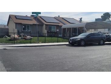 Charming single-story home featuring solar panels and a well-maintained front yard with secure car port at 6231 Santa Maria Ave, Las Vegas, NV 89108