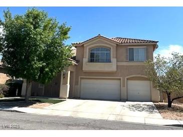 Two-story home with a two-car garage and tile roof, complemented by mature landscaping at 6351 Davidson Ct, Las Vegas, NV 89110