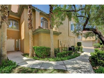 Inviting entryway with a well-maintained lawn and mature palm trees at 8717 Red Brook Dr # 201, Las Vegas, NV 89128