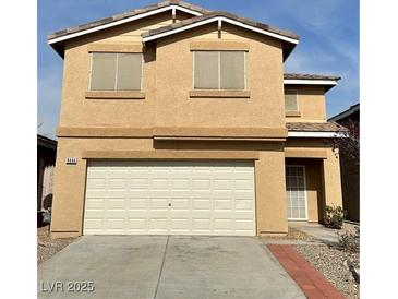 Two-story home featuring a two-car garage and neutral stucco exterior at 9844 Ashton Pines Ct, Las Vegas, NV 89147
