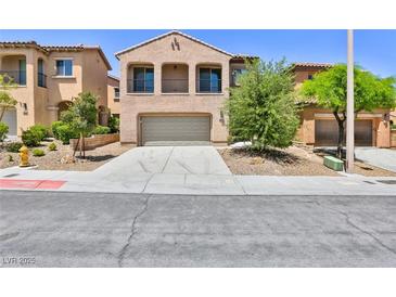 Charming two-story home featuring a desert landscape and a two-car attached garage at 11816 Orense Dr, Las Vegas, NV 89138