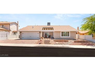 Charming single-story home featuring a landscaped front yard and a two-car attached garage at 1505 Irene Dr, Boulder City, NV 89005