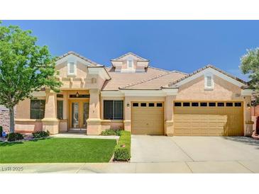 Charming single-story home with a well-manicured lawn, desert landscaping and a three-car garage at 2150 Ponticello Dr, Henderson, NV 89052