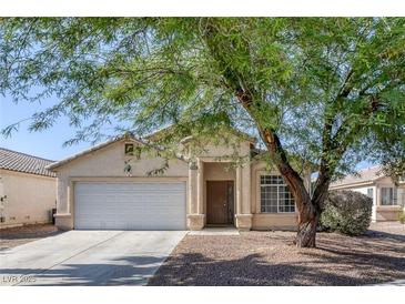 Charming single-story home with a well-maintained front yard and covered entrance at 2410 Morocco Ave, North Las Vegas, NV 89031