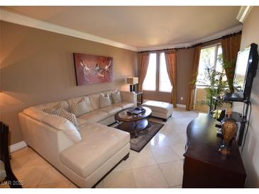 Inviting living room features a comfortable sectional sofa, stylish decor, and abundant natural light at 270 E Flamingo Rd # 319, Las Vegas, NV 89169