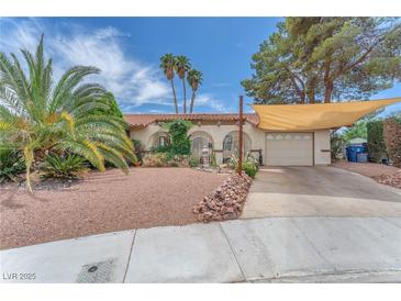 Charming single-story home with desert landscaping, shade covering, and an attached two-car garage at 3158 La Luna Cir, Henderson, NV 89014