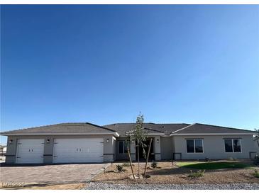 Beautiful single story home with a three car garage, desert landscaping, and a tile roof at 3791 Soplo Rd, Pahrump, NV 89048