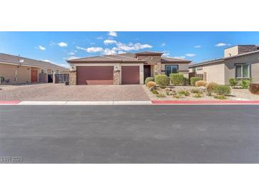 Charming single-story home with a three-car garage, stone accents, and well-maintained landscaping at 4510 Rubious Ave, North Las Vegas, NV 89084