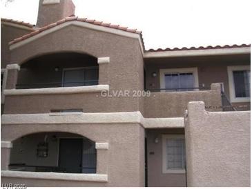 Two-story condo with balconies and neutral-colored stucco exterior at 5220 Mission Carmel Ln # 207, Las Vegas, NV 89107