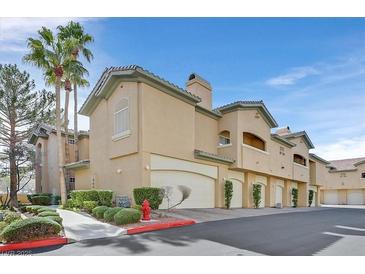 Inviting condo complex featuring well-maintained landscaping and private garage spaces at 8737 Red Brook Dr # 201, Las Vegas, NV 89128