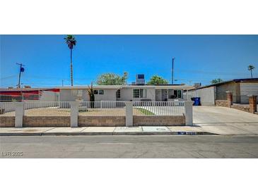 Charming single-story home featuring a desert landscape, secure fence, and a well-maintained front yard at 1816 Silver Birch Ln, Las Vegas, NV 89104