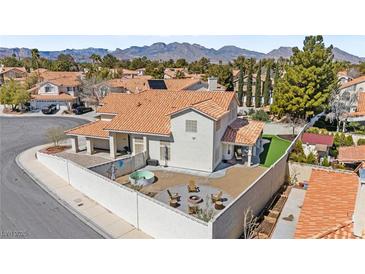 This backyard features a fire pit, lounge seating, an above ground pool, and mountain views at 2021 Summit Pointe Dr, Las Vegas, NV 89117