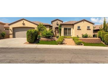 Charming single-story home featuring desert landscaping, a brick walkway, and an attached two-car garage at 2373 Ozark Plateau Dr, Henderson, NV 89044