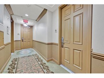 Condo hallway with patterned carpet and entry doors at 2455 W Serene Ave # 851, Las Vegas, NV 89123