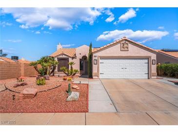 Single-story home featuring well-manicured landscaping and a two-car garage at 420 Aloha Dr, Henderson, NV 89015
