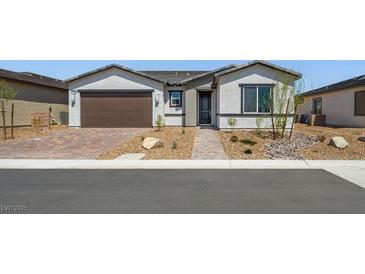 Charming single-story home with a well-maintained front yard and a two-car garage at 4450 E Brusca Ct, Pahrump, NV 89061