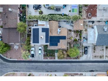 An aerial view of a home with solar panels, landscaped yard, and neighborhood surroundings at 605 N 4Th St, Las Vegas, NV 89101