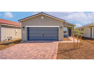 Charming single-story home featuring a two-car garage and a brick paved driveway at 6761 Violet Cascade Ave, Las Vegas, NV 89156