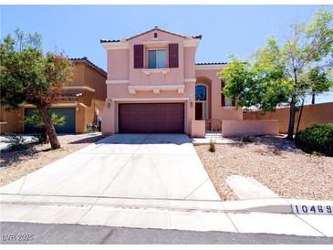 Charming two-story home with a well-maintained front yard and a two car garage at 10469 Mulvaney Cir, Las Vegas, NV 89141