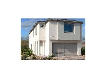 Modern two-story home with a gray garage door and white stucco exterior at 11881 Pied Harrier Ave, Las Vegas, NV 89138