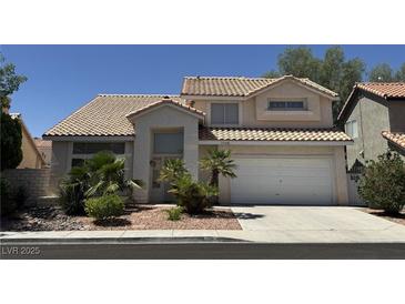 Charming two-story home featuring a tile roof, desert landscaping, and an attached two car garage at 1745 Walingwood Dr, North Las Vegas, NV 89031