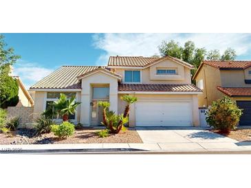 Charming two-story home featuring a tile roof, desert landscaping, and an attached two car garage at 1745 Walingwood Dr, North Las Vegas, NV 89031