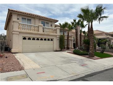 Two-story stucco home with a two-car garage, balcony, and desert landscaping at 3340 Shallow Pond Dr, Las Vegas, NV 89117