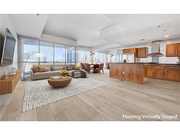 Bright, open-concept living space features floor-to-ceiling windows and modern kitchen at 4525 Dean Martin Dr # 909, Las Vegas, NV 89103