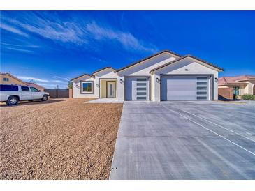 Charming single-story home boasting a two-car garage and desert landscaping, perfect for low maintenance at 4861 Ridgewood, Pahrump, NV 89061