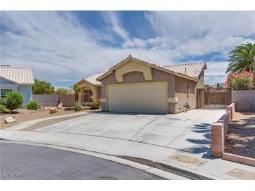 Charming one-story home with a two-car garage and a well-maintained front yard at 5116 Blue Onion Cir, North Las Vegas, NV 89031