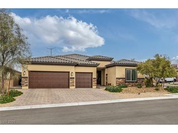 Charming single story home with a three car garage and a beautifully landscaped front yard at 5234 Savannah Rose St, Las Vegas, NV 89149
