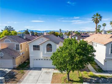Charming two-story home featuring an attached garage, mountain views and mature trees at 5984 Emerald Canyon Dr, Las Vegas, NV 89142