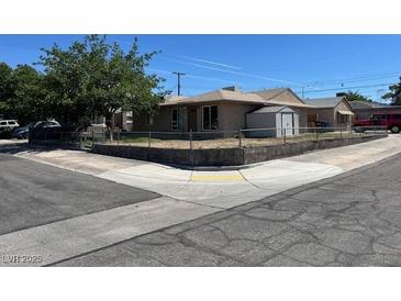 Charming single-story home with a well-maintained yard and a detached storage shed at 600 Federal St, Henderson, NV 89015