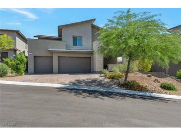 Contemporary two-story home featuring a three-car garage, xeriscaped yard and mature shade tree at 754 Tallgrass St, Las Vegas, NV 89138