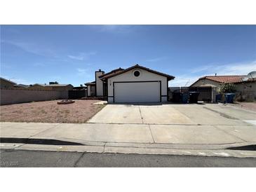 Charming single-story home featuring a two-car garage and low-maintenance desert landscaping at 1003 Palo Verde Dr, Henderson, NV 89015