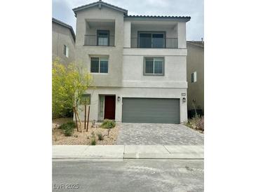 Two-story home featuring dual balconies and a well-manicured, low-maintenance front yard at 10376 Joaquin Fire St, Las Vegas, NV 89141