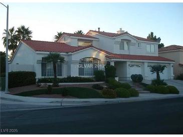 Inviting two-story home with a red tile roof and a well-manicured front yard at 185 Camrose St, Henderson, NV 89074