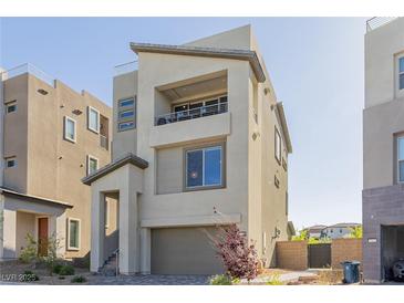 Contemporary two-story home with balcony, neutral stucco, well-kept front yard, and convenient attached two-car garage at 2151 Noble Perch St, Las Vegas, NV 89138