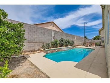 Private backyard pool with a soothing water feature provides relaxation and enjoyment at 3539 Barrel Bronco Ct, North Las Vegas, NV 89032
