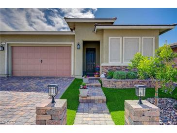 Charming single-story home with a well-manicured lawn and a welcoming brick walkway at 505 Sterling Falls Ave, Henderson, NV 89011