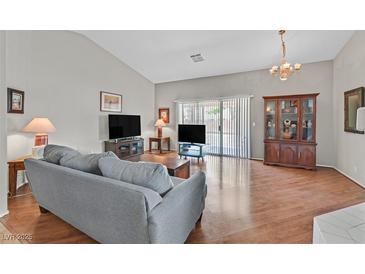 Spacious living room with hardwood floors, vaulted ceiling and natural light throughout at 6125 Desert Haven Rd, Las Vegas, NV 89130