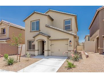Charming two-story home featuring a tan stucco exterior, a well-manicured yard, and an attached garage at 6443 Burlap Ct, Las Vegas, NV 89122
